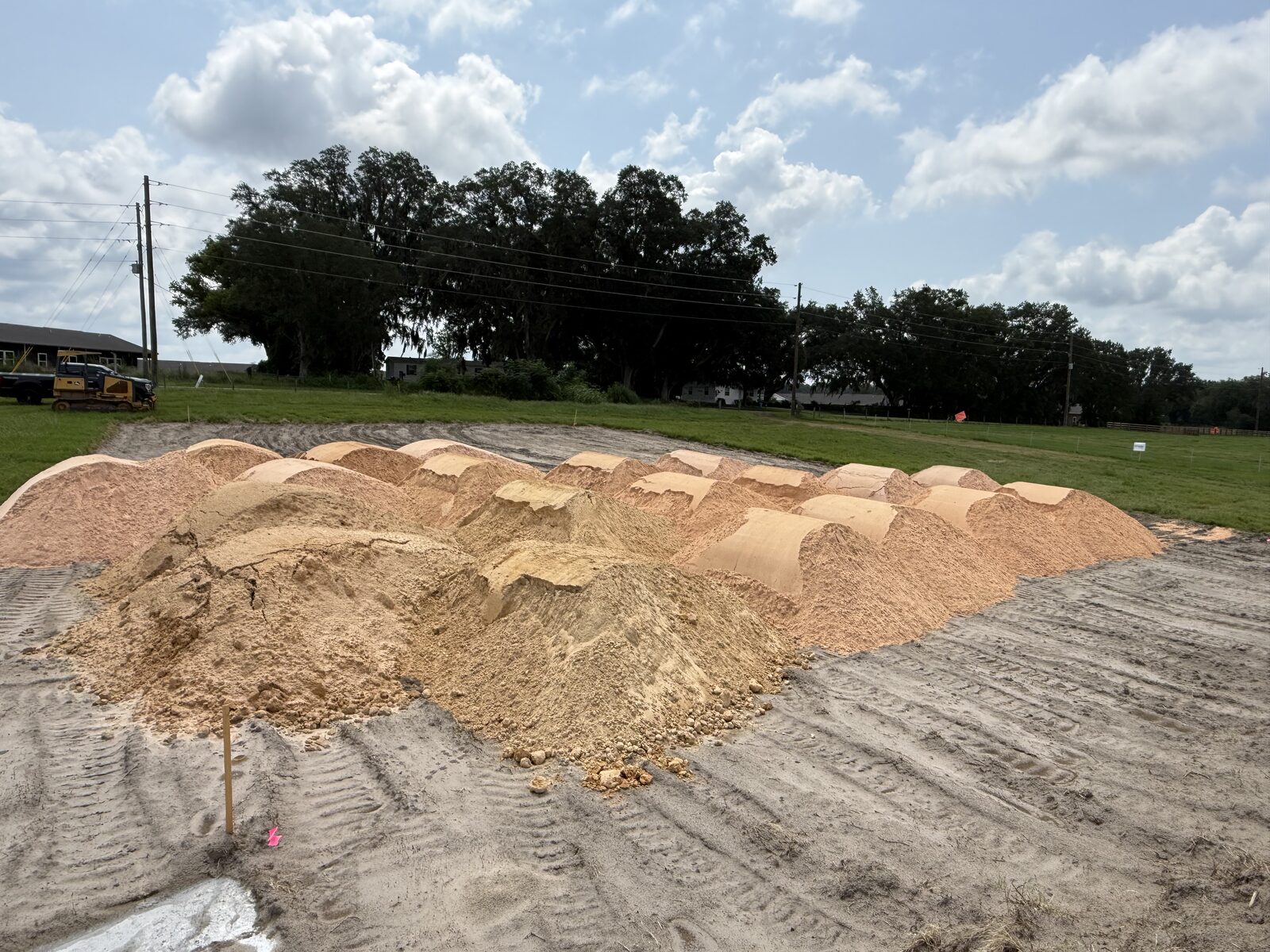 Fill dirt piles staged on a prepared job site